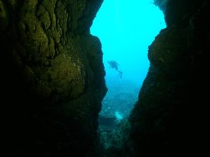 diver hovering outside a pass-through