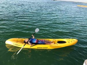 boy taking a nap in a kayak