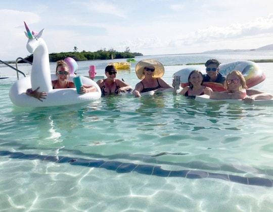 group enjoying pool toys