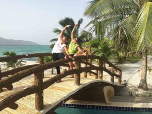 guests doing yoga on the beach